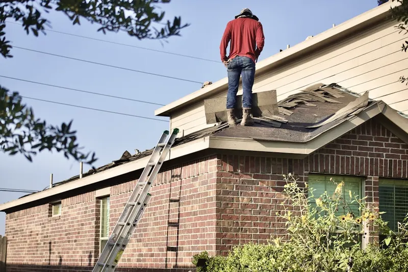 Professional roofer working on a residential roof in Camp Creek Estates